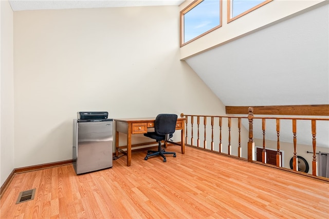 office area featuring hardwood / wood-style floors and vaulted ceiling