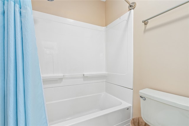 bathroom featuring shower / bathtub combination with curtain and toilet