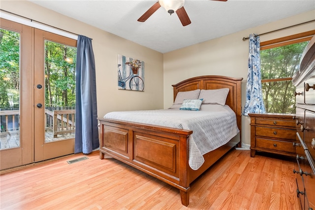 bedroom featuring access to exterior, light hardwood / wood-style floors, and ceiling fan