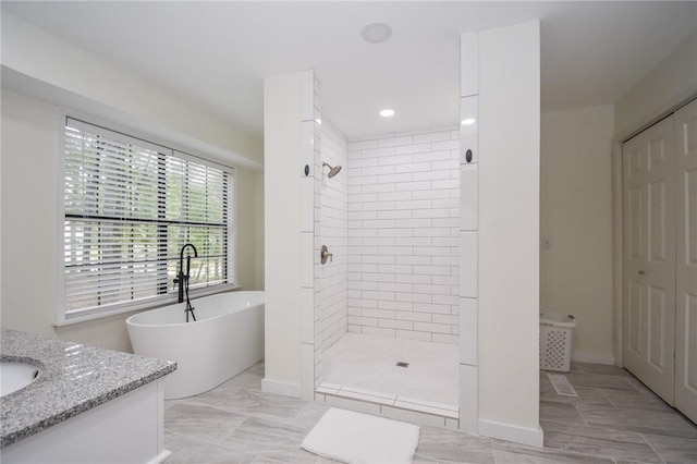 bathroom with vanity and separate shower and tub