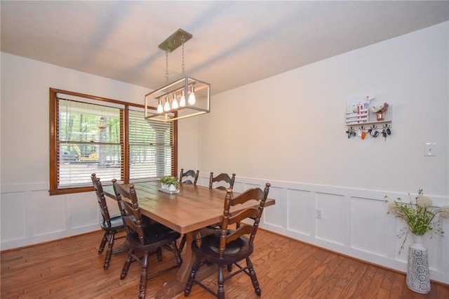 dining space featuring a chandelier and wood-type flooring