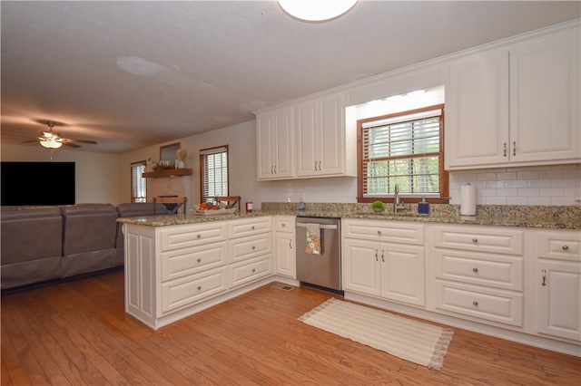 kitchen featuring dishwasher, kitchen peninsula, light hardwood / wood-style floors, decorative backsplash, and white cabinets