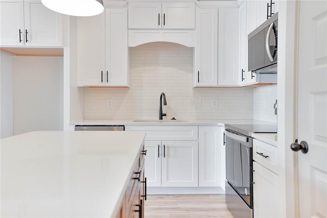 305 Northgate Blvd, Auburn, AL 36830 - kitchen with stainless steel appliances, a sink, light countertops, and white cabinets