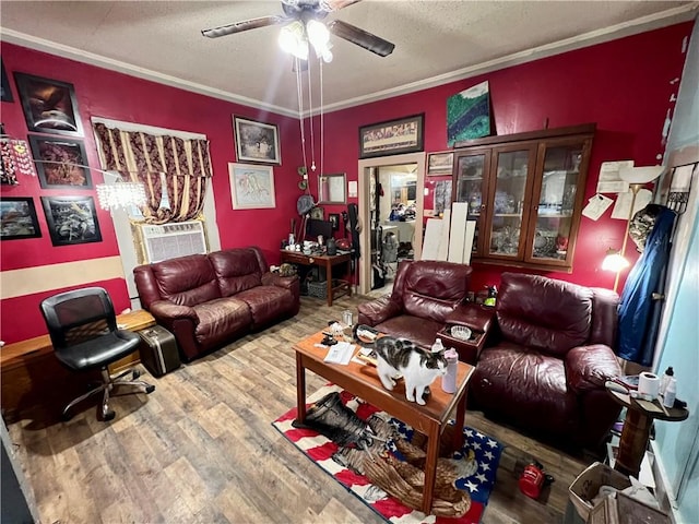 living room with cooling unit, a textured ceiling, wood finished floors, and crown molding