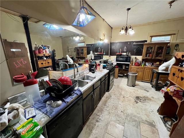 kitchen featuring a sink, hanging light fixtures, black microwave, stainless steel gas range oven, and a chandelier