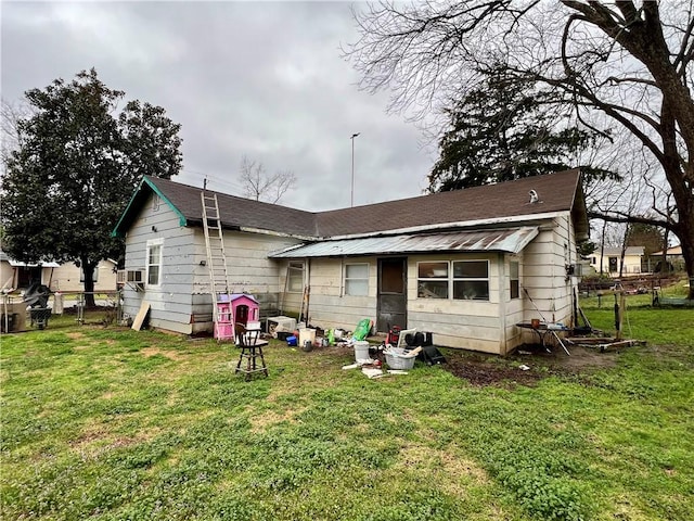 back of house featuring a lawn and fence