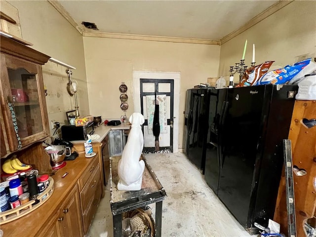 miscellaneous room with crown molding and unfinished concrete floors