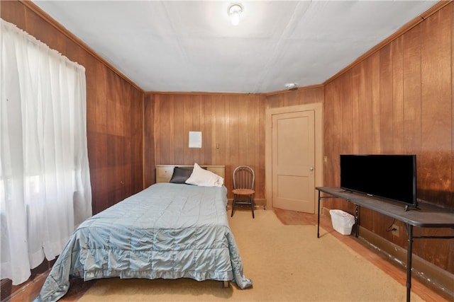bedroom featuring wood walls and carpet