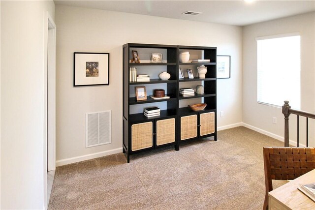 interior space featuring visible vents, baseboards, and carpet