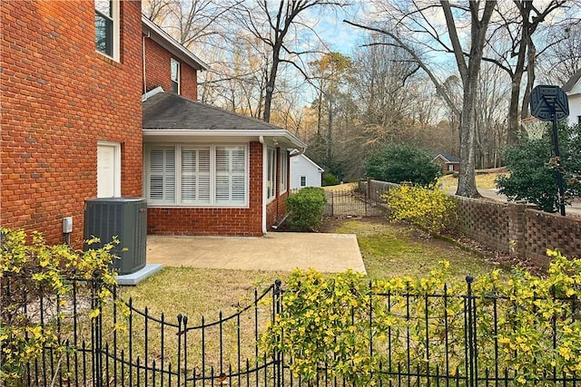 view of yard featuring central air condition unit, a patio, and a fenced backyard