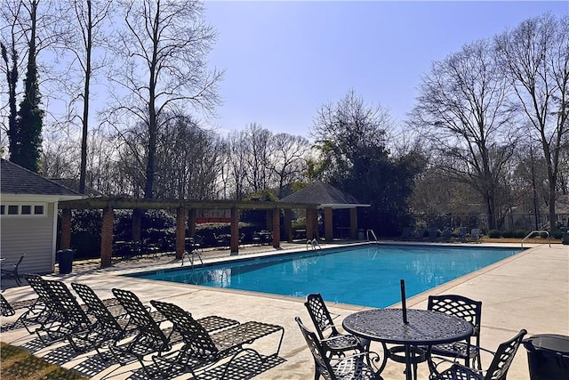 community pool with a gazebo, fence, and a patio