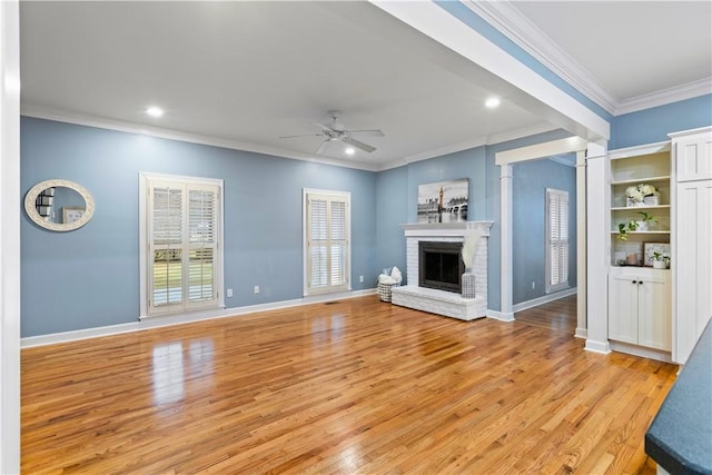 unfurnished living room featuring crown molding, a ceiling fan, and light wood finished floors