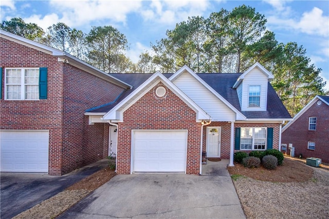 view of front of home with driveway, brick siding, and an attached garage