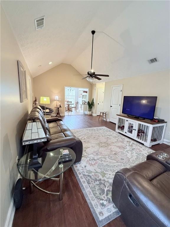 living room with wood-type flooring, vaulted ceiling, and ceiling fan