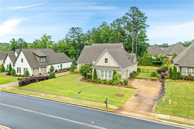 1843 Yarbrough Farms Blvd, Auburn, AL 36830 - view of front of property featuring concrete driveway, board and batten siding, an attached garage, roof with shingles, and stone siding