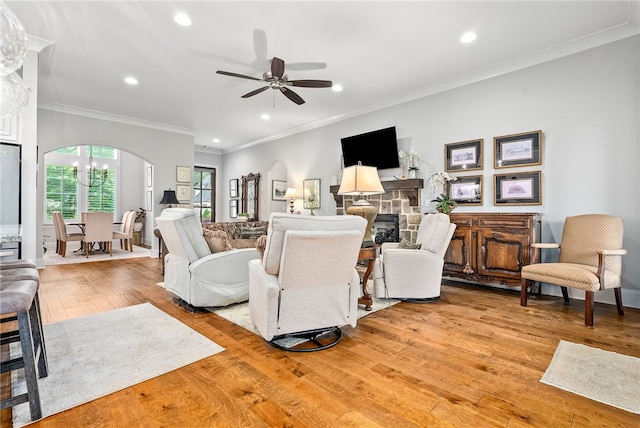 1843 Yarbrough Farms Blvd, Auburn, AL 36830 - living room featuring arched walkways, recessed lighting, light wood-style floors, a ceiling fan, and crown molding