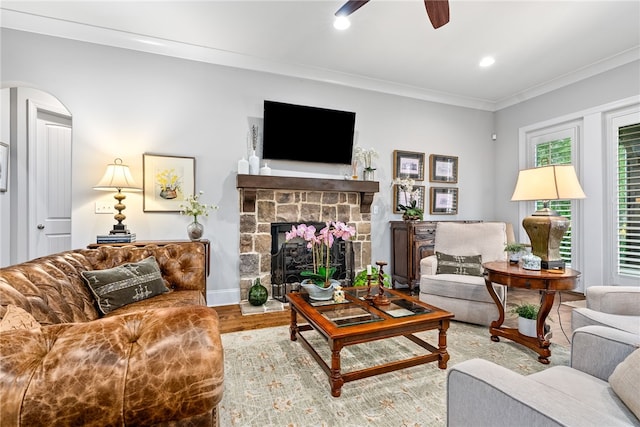 1843 Yarbrough Farms Blvd, Auburn, AL 36830 - living room featuring a ceiling fan, wood finished floors, arched walkways, a fireplace, and ornamental molding