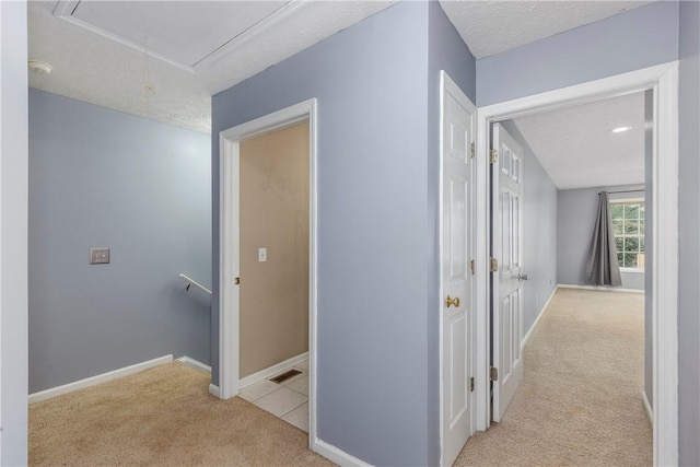 2428 E University Dr Unit 904, Auburn, AL 36830 - hall featuring attic access, carpet, an upstairs landing, baseboards, and a textured ceiling