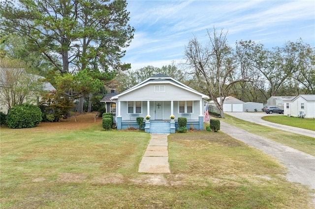 view of front of home with covered porch and a front lawn