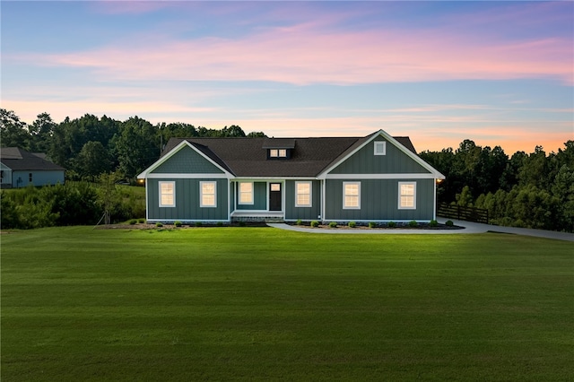 view of front of house with a yard and board and batten siding