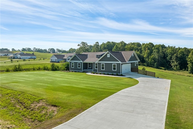 view of front of house with board and batten siding, an attached garage, driveway, and a front yard