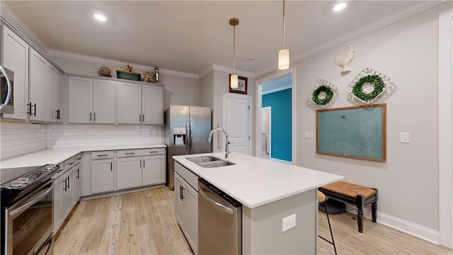 574 Grey Oak Cir, Auburn, AL 36830 - kitchen featuring appliances with stainless steel finishes, gray cabinetry, light wood finished floors, backsplash, and ornamental molding