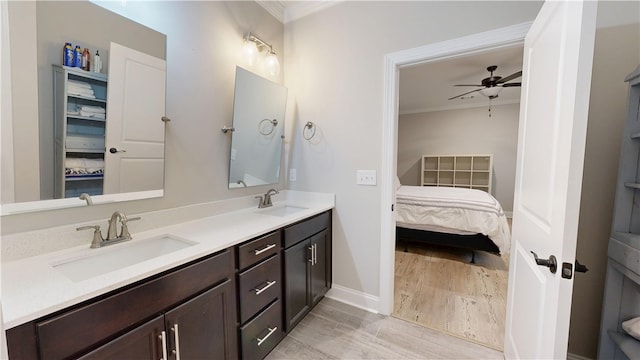 574 Grey Oak Cir, Auburn, AL 36830 - ensuite bathroom with ornamental molding, double vanity, a ceiling fan, and wood finished floors