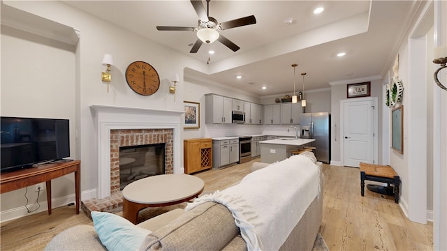 574 Grey Oak Cir, Auburn, AL 36830 - living area with light wood-type flooring, a fireplace, a ceiling fan, crown molding, and recessed lighting