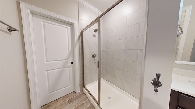 574 Grey Oak Cir, Auburn, AL 36830 - bathroom featuring vanity, a tile shower, wood finished floors, and crown molding