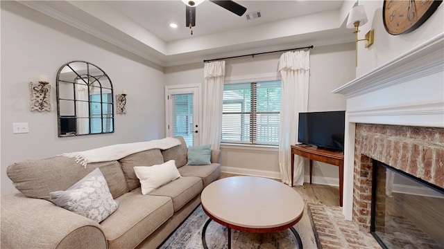 574 Grey Oak Cir, Auburn, AL 36830 - living area with a fireplace, ceiling fan, wood finished floors, recessed lighting, and a raised ceiling