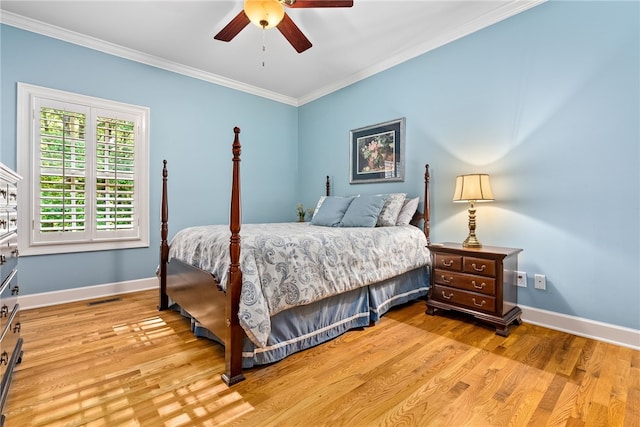 bedroom featuring ceiling fan, crown molding, and light hardwood / wood-style flooring