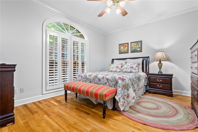 bedroom with ceiling fan, light wood-type flooring, and ornamental molding