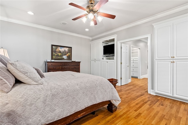 bedroom with ceiling fan, crown molding, and light hardwood / wood-style flooring