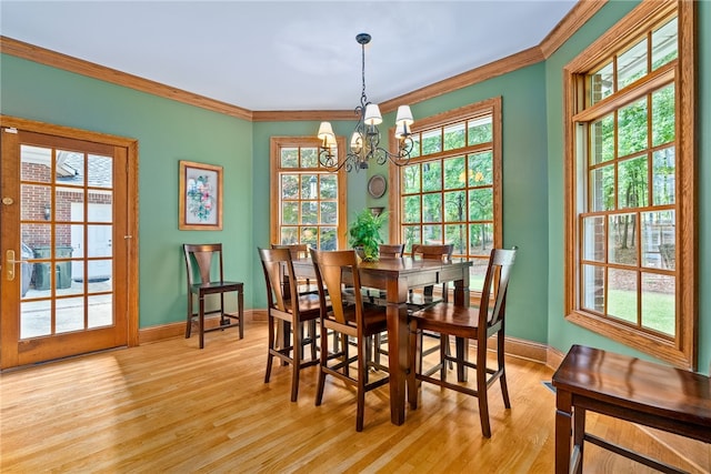 dining room featuring crown molding, a chandelier, and light wood-type flooring