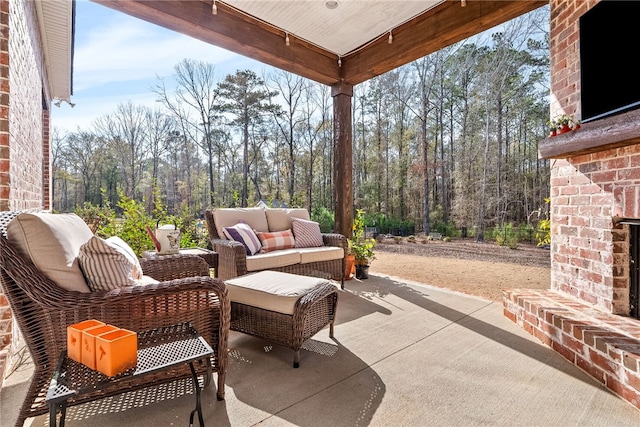 view of patio / terrace with an outdoor living space with a fireplace