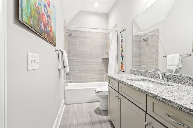 full bathroom featuring lofted ceiling, vanity, toilet, and shower / bath combo