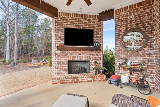 view of patio with an outdoor brick fireplace and ceiling fan