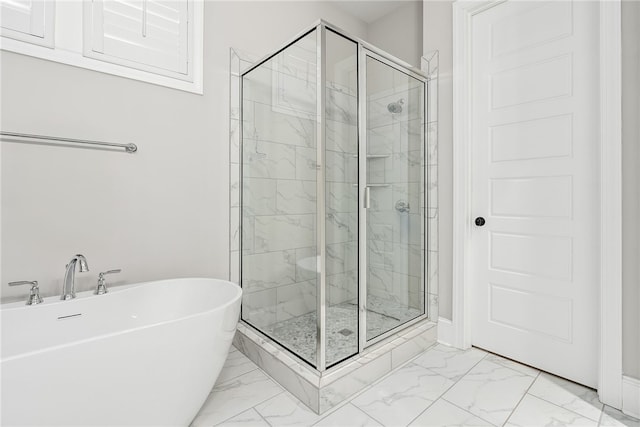 bathroom featuring separate shower and tub