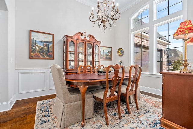 dining area featuring an inviting chandelier, a wealth of natural light, ornamental molding, and dark hardwood / wood-style floors