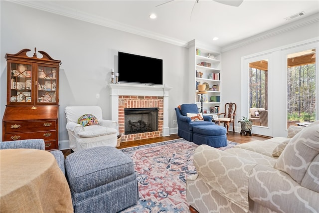 bedroom with a brick fireplace, crown molding, wood-type flooring, and access to exterior