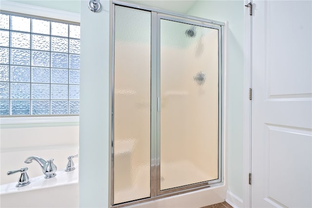 bathroom featuring independent shower and bath