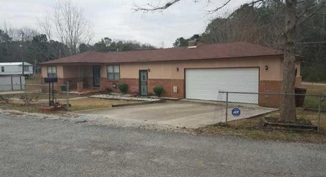30 Bay St, Tuskegee, AL 36083 - ranch-style home with driveway, a garage, and brick siding