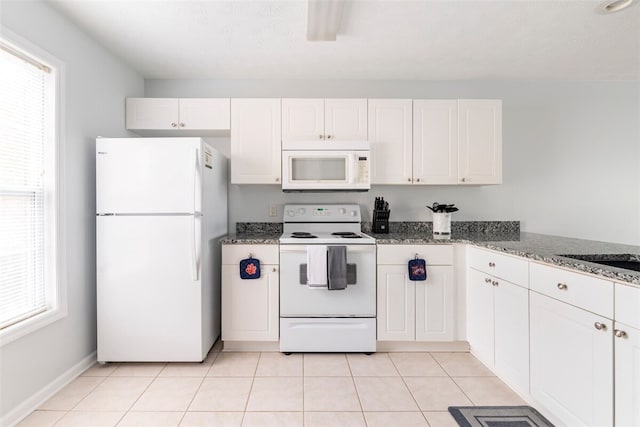 1477 N Donahue Dr N Unit 1602, Auburn, AL 36830 - kitchen with white appliances, white cabinetry, dark stone counters, and light tile patterned floors