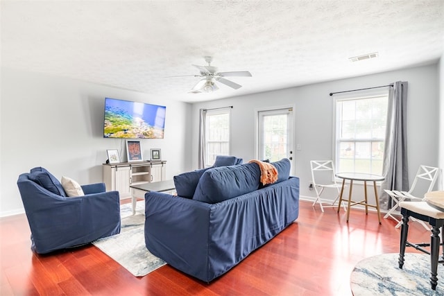 1477 N Donahue Dr N Unit 1602, Auburn, AL 36830 - living room featuring wood finished floors, baseboards, a ceiling fan, and a textured ceiling