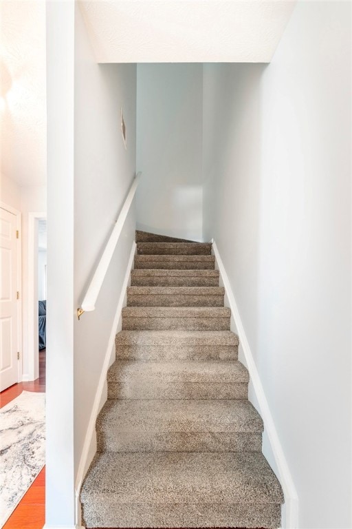 1477 N Donahue Dr N Unit 1602, Auburn, AL 36830 - stairway with wood finished floors and baseboards