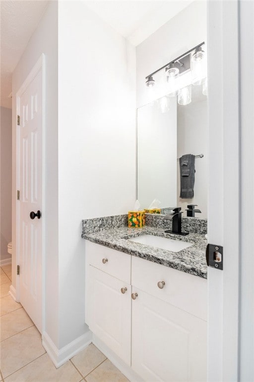 1477 N Donahue Dr N Unit 1602, Auburn, AL 36830 - bathroom featuring vanity, tile patterned floors, toilet, and baseboards