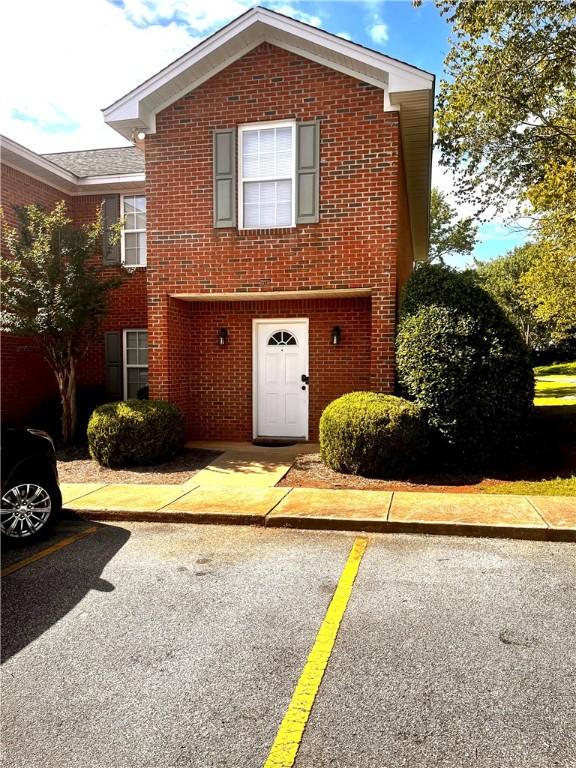 1477 N Donahue Dr N Unit 1602, Auburn, AL 36830 - traditional home featuring brick siding and uncovered parking