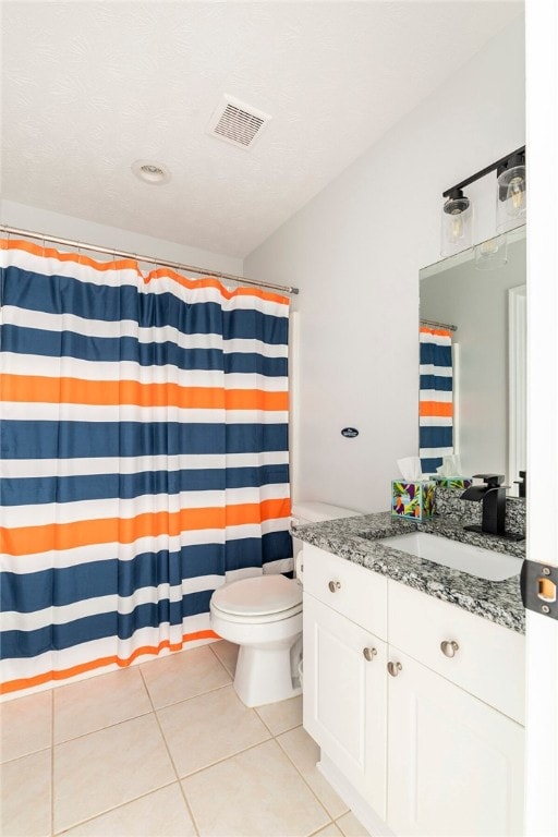 1477 N Donahue Dr N Unit 1602, Auburn, AL 36830 - full bath featuring vanity, toilet, tile patterned flooring, and a shower with shower curtain