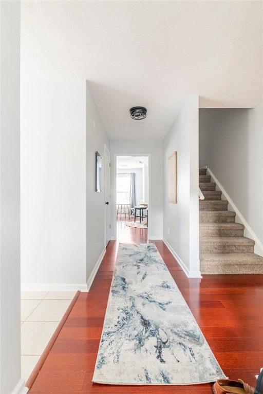 1477 N Donahue Dr N Unit 1602, Auburn, AL 36830 - hall with stairway, wood finished floors, and baseboards