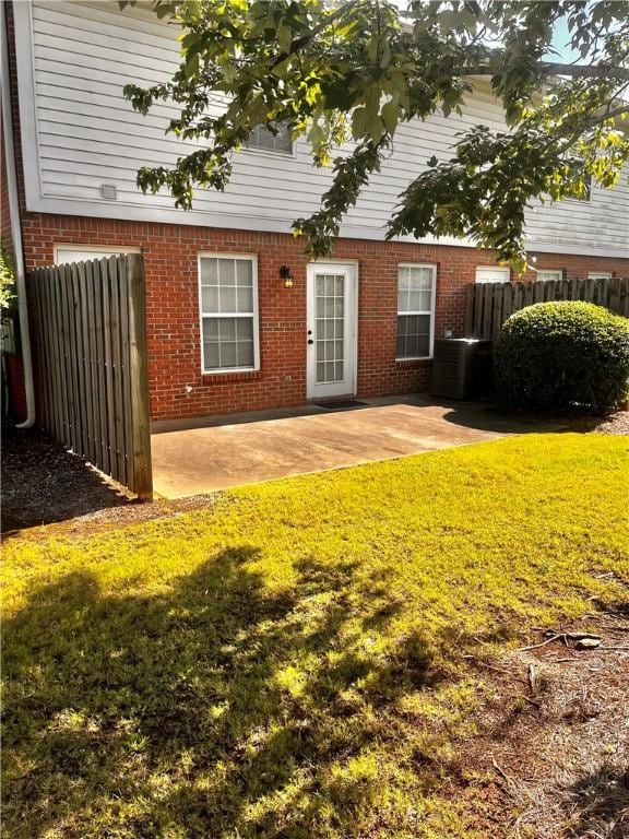 1477 N Donahue Dr N Unit 1602, Auburn, AL 36830 - rear view of property with brick siding, a patio area, and central air condition unit